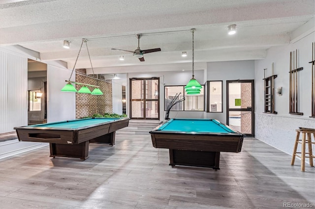 recreation room with wood-type flooring, a textured ceiling, and billiards