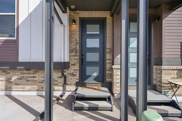 entrance to property with brick siding