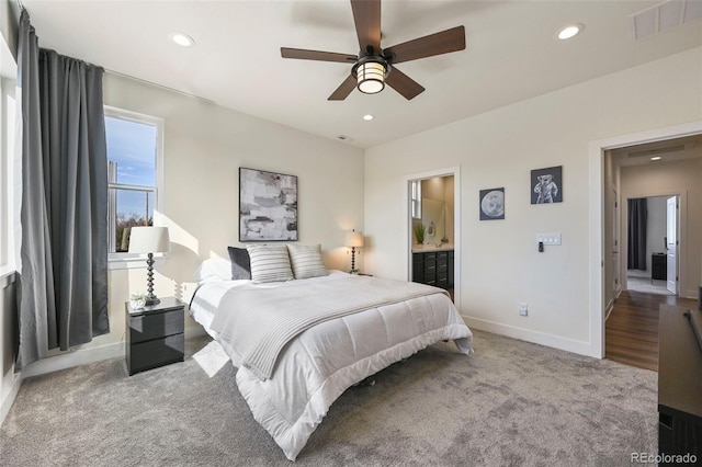 bedroom with visible vents, baseboards, ensuite bathroom, carpet, and recessed lighting