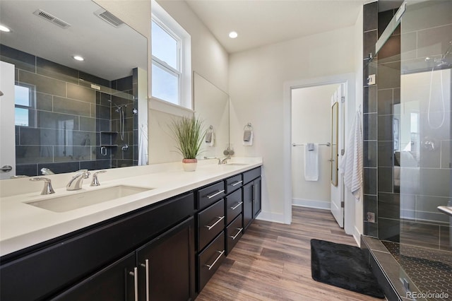 full bathroom featuring a stall shower, visible vents, and a sink