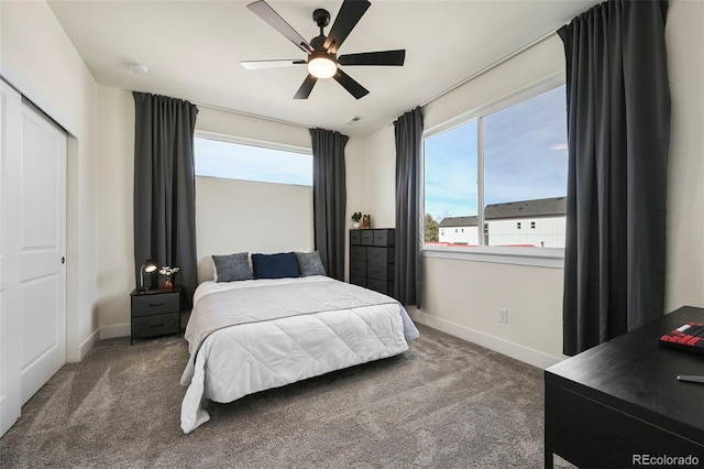 carpeted bedroom with a ceiling fan, visible vents, and baseboards