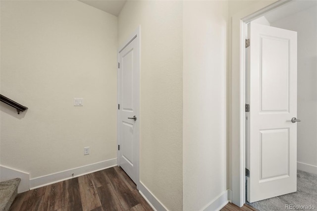 hallway featuring wood finished floors and baseboards