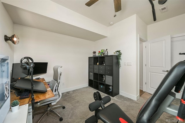 carpeted home office featuring baseboards, visible vents, and a ceiling fan