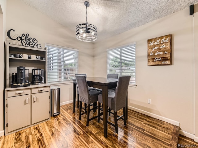 2104 Vineyard Dr, Castle Rock, CO 80104 - dining area with a textured ceiling, a chandelier, and light wood-style floors