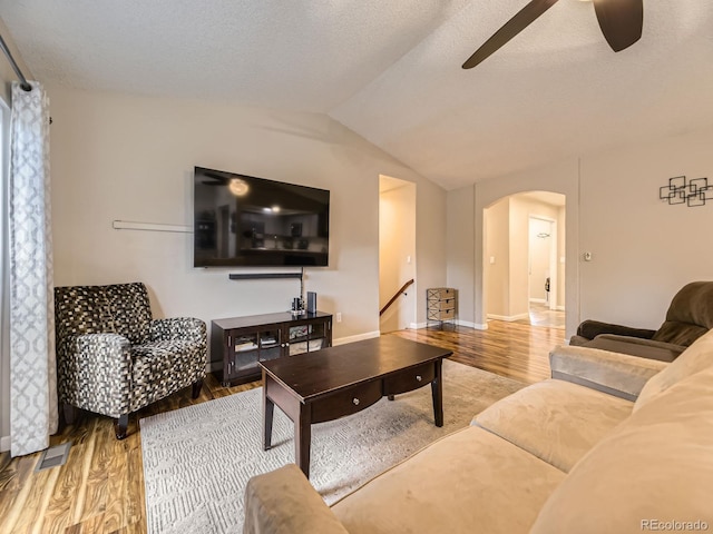 2104 Vineyard Dr, Castle Rock, CO 80104 - living room featuring arched walkways, a ceiling fan, wood finished floors, lofted ceiling, and a textured ceiling