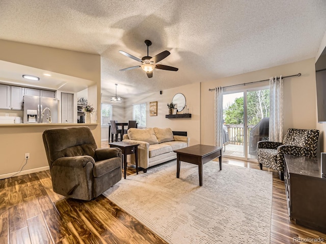 2104 Vineyard Dr, Castle Rock, CO 80104 - living area with a textured ceiling, healthy amount of natural light, dark wood-style floors, and a ceiling fan