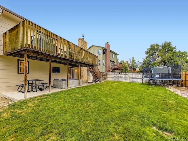 2104 Vineyard Dr, Castle Rock, CO 80104 - fenced backyard featuring a trampoline, a deck, a patio area, and stairway
