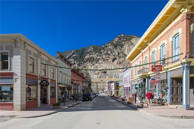 808 Rose St, Georgetown, CO 80444 - view of asphalt street with sidewalks, curbs, a mountain view, and street lighting