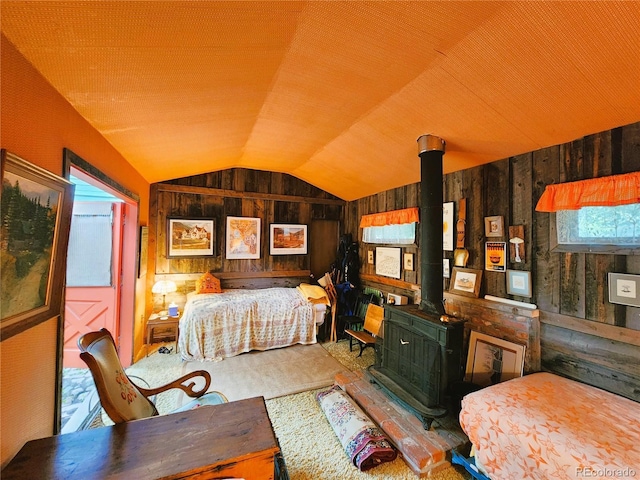 808 Rose St, Georgetown, CO 80444 - bedroom featuring a wood stove, wooden walls, vaulted ceiling, and carpet flooring