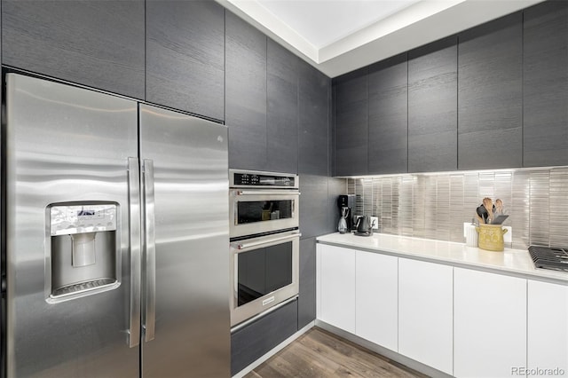 4200 W 17th Ave Unit 212, Denver, CO 80204 - kitchen featuring stainless steel appliances, modern cabinets, and wood finished floors