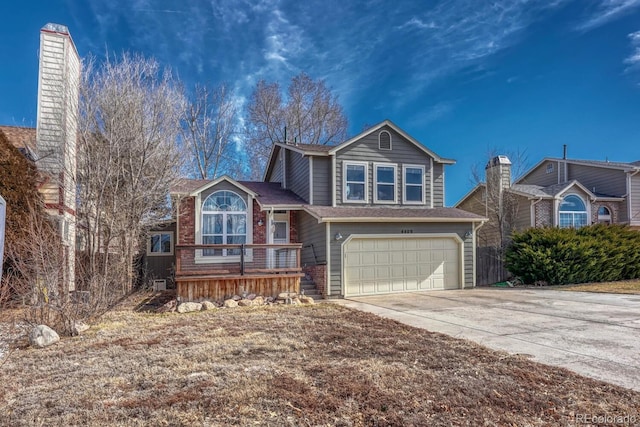 tri-level home featuring concrete driveway and an attached garage