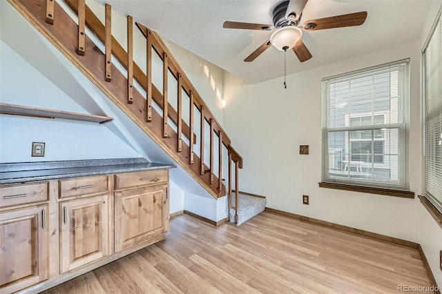 stairs with ceiling fan and wood-type flooring