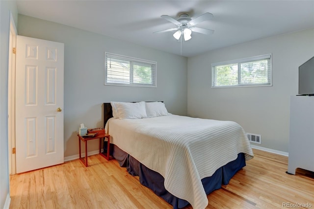 5690 E Cornell Ave, Denver, CO 80222 - bedroom featuring multiple windows, light wood-style floors, and ceiling fan