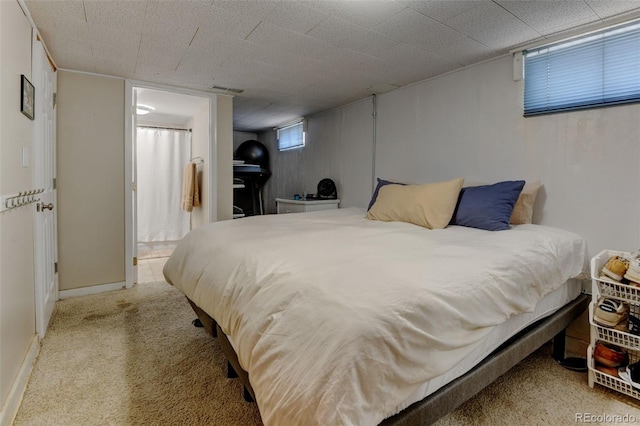 5690 E Cornell Ave, Denver, CO 80222 - carpeted bedroom featuring ensuite bathroom and baseboards