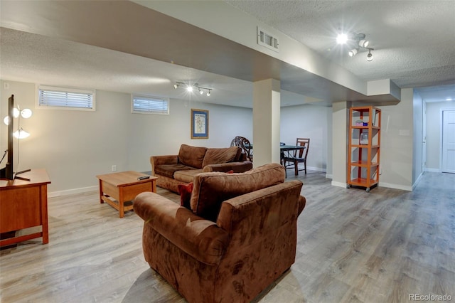 5690 E Cornell Ave, Denver, CO 80222 - living room with a textured ceiling, light wood-style floors, and track lighting