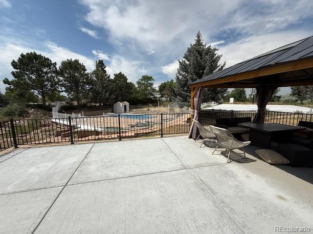 1545 W 148th Ave, Westminster, CO 80023 - fenced backyard with a gazebo, a patio, and a storage unit