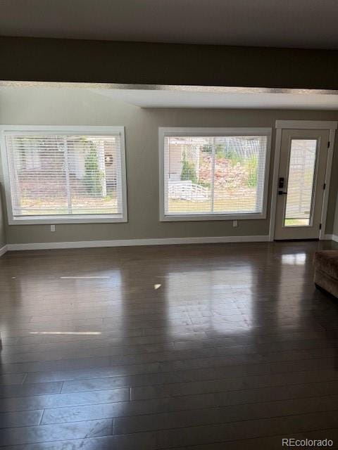 1545 W 148th Ave, Westminster, CO 80023 - spare room featuring baseboards and dark wood finished floors