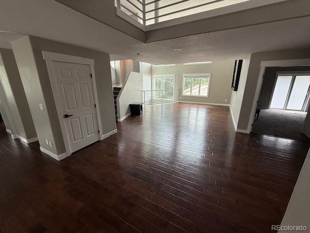 1545 W 148th Ave, Westminster, CO 80023 - unfurnished living room with stairway and dark wood-type flooring