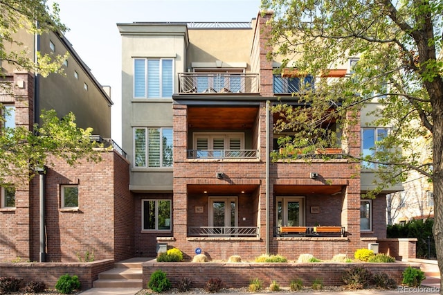 907 E 22nd Ave, Denver, CO 80205 - back of property with a balcony, brick siding, and stucco siding