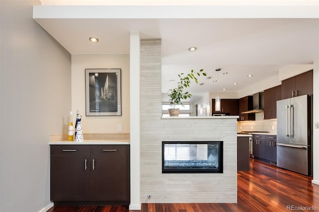 907 E 22nd Ave, Denver, CO 80205 - bar area featuring high end fridge, wall chimney range hood, dark wood-style floors, recessed lighting, and decorative light fixtures