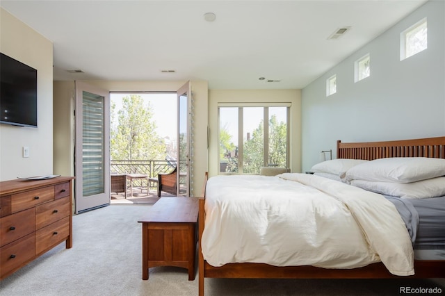 907 E 22nd Ave, Denver, CO 80205 - bedroom with access to outside and light carpet