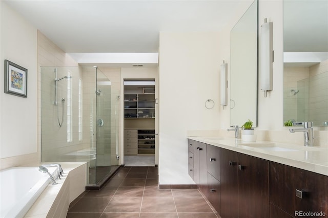 907 E 22nd Ave, Denver, CO 80205 - full bathroom featuring a stall shower, double vanity, a bath, tile patterned flooring, and a spacious closet