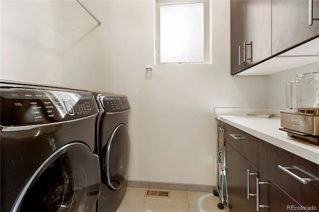 907 E 22nd Ave, Denver, CO 80205 - laundry room with cabinet space, separate washer and dryer, and light tile patterned floors