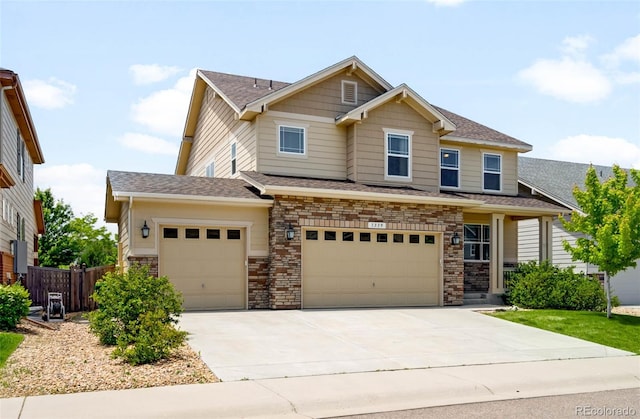 1339 Sidewinder Cir, Castle Rock, CO 80108 - view of front facade featuring driveway, an attached garage, stone siding, and a shingled roof
