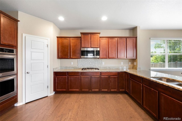 1339 Sidewinder Cir, Castle Rock, CO 80108 - kitchen with stainless steel appliances, light wood-type flooring, light stone counters, and recessed lighting