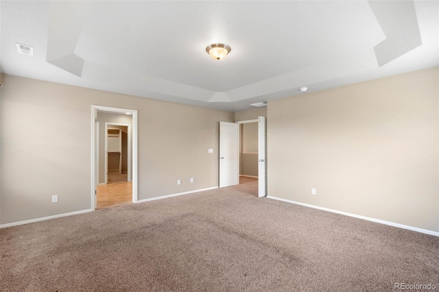 1339 Sidewinder Cir, Castle Rock, CO 80108 - unfurnished bedroom featuring a raised ceiling, light carpet, and a spacious closet