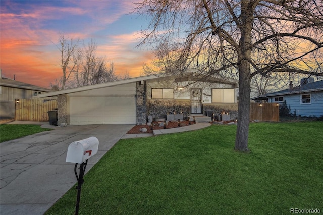 ranch-style house with a yard and a garage