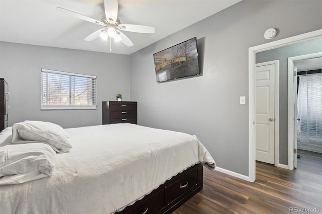 bedroom featuring dark wood-type flooring, ceiling fan, lofted ceiling, and ensuite bath