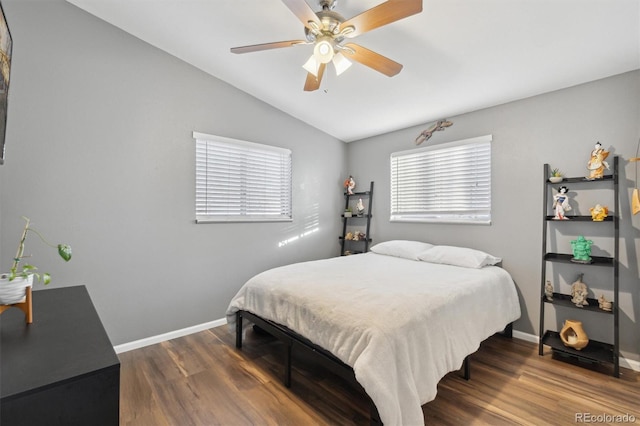 bedroom featuring vaulted ceiling, ceiling fan, and dark hardwood / wood-style flooring