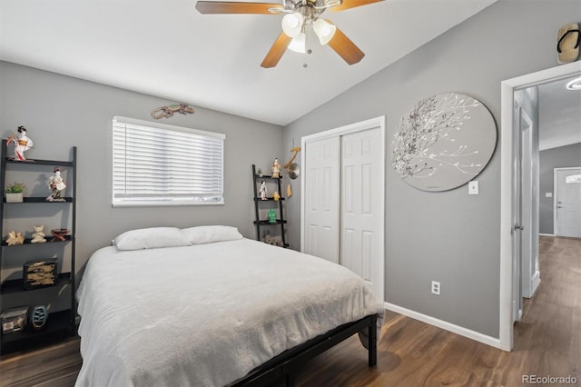 bedroom with ceiling fan, dark wood-type flooring, a closet, and vaulted ceiling