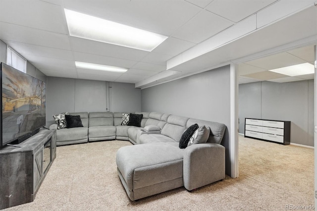 carpeted living room with a drop ceiling