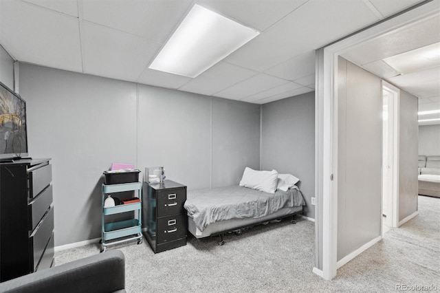 carpeted bedroom with a paneled ceiling