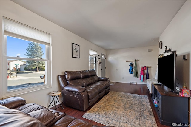 living area featuring dark wood finished floors and baseboards