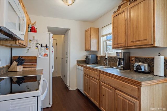 kitchen featuring white appliances, a sink, backsplash, tile counters, and dark wood-style floors