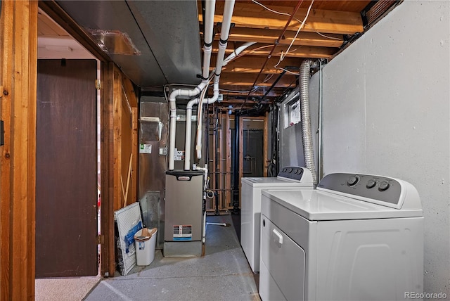 clothes washing area featuring laundry area, washing machine and dryer, and heating unit