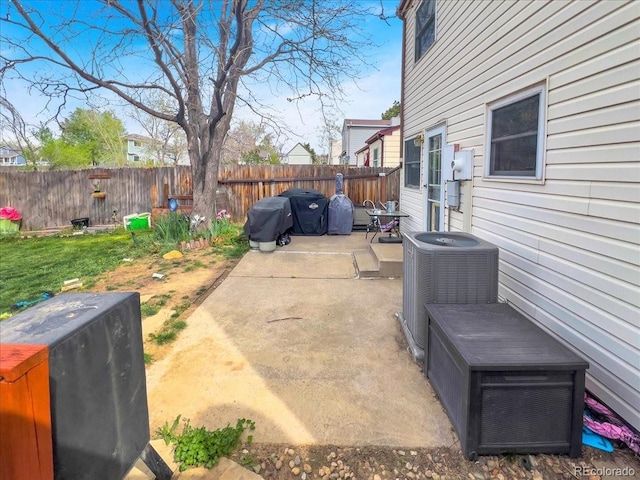 view of patio / terrace with central air condition unit and fence