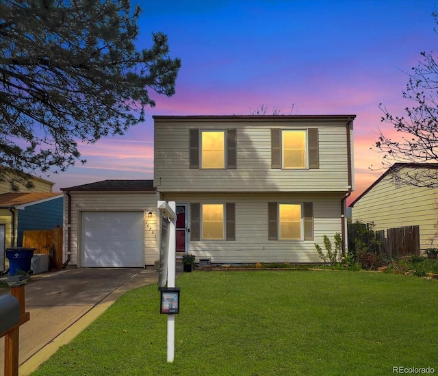 view of front of house with an attached garage, a front lawn, fence, and concrete driveway