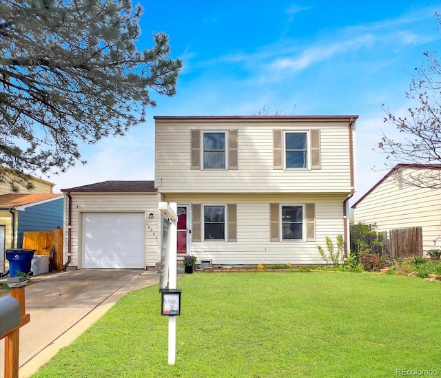 colonial house with an attached garage, a front lawn, fence, and concrete driveway