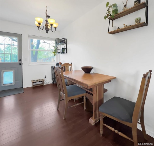 dining room featuring a notable chandelier and dark wood-style floors