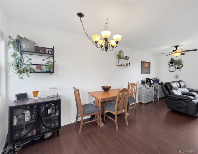 dining space featuring ceiling fan with notable chandelier and wood finished floors