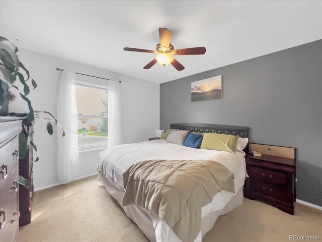 bedroom with baseboards, light carpet, and ceiling fan
