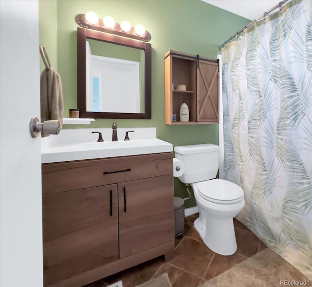 bathroom featuring tile patterned floors, vanity, toilet, and curtained shower