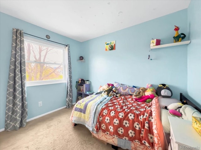 carpeted bedroom featuring baseboards