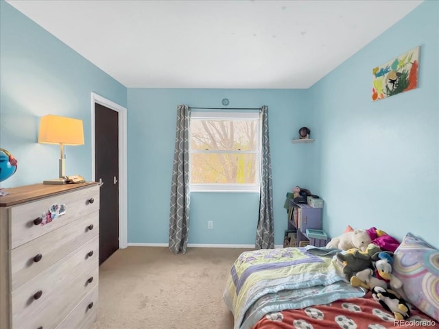 bedroom with baseboards and carpet