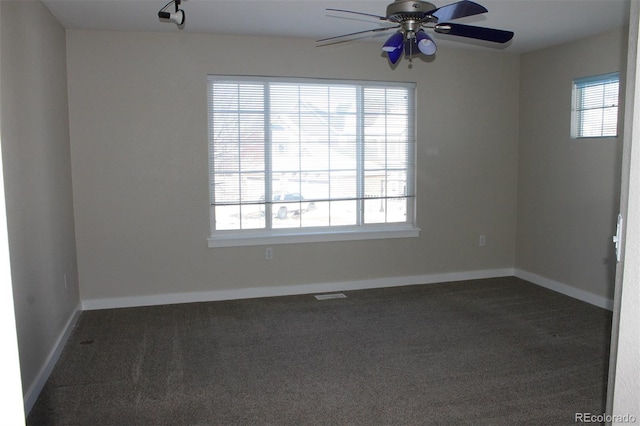 carpeted spare room featuring ceiling fan