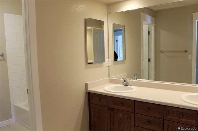 bathroom with vanity, shower / bath combination, and tile patterned flooring